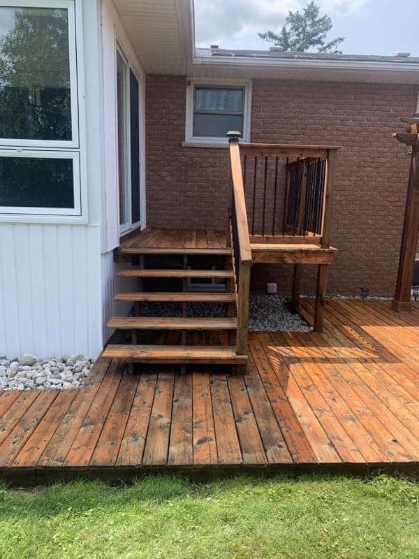 Freshly stained deck - warm brown finish on pressure-treated wood - Hamilton Ontario